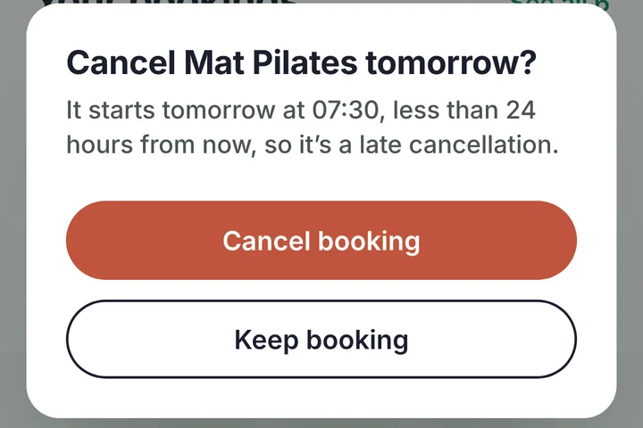 A cancel dialog on a phone: Cancel Mat Pilates tomorrow? It starts tomorrow at 07:30, less than 24 hours from now, so it is a late cancellation. Buttons: Cancel booking and Keep booking.